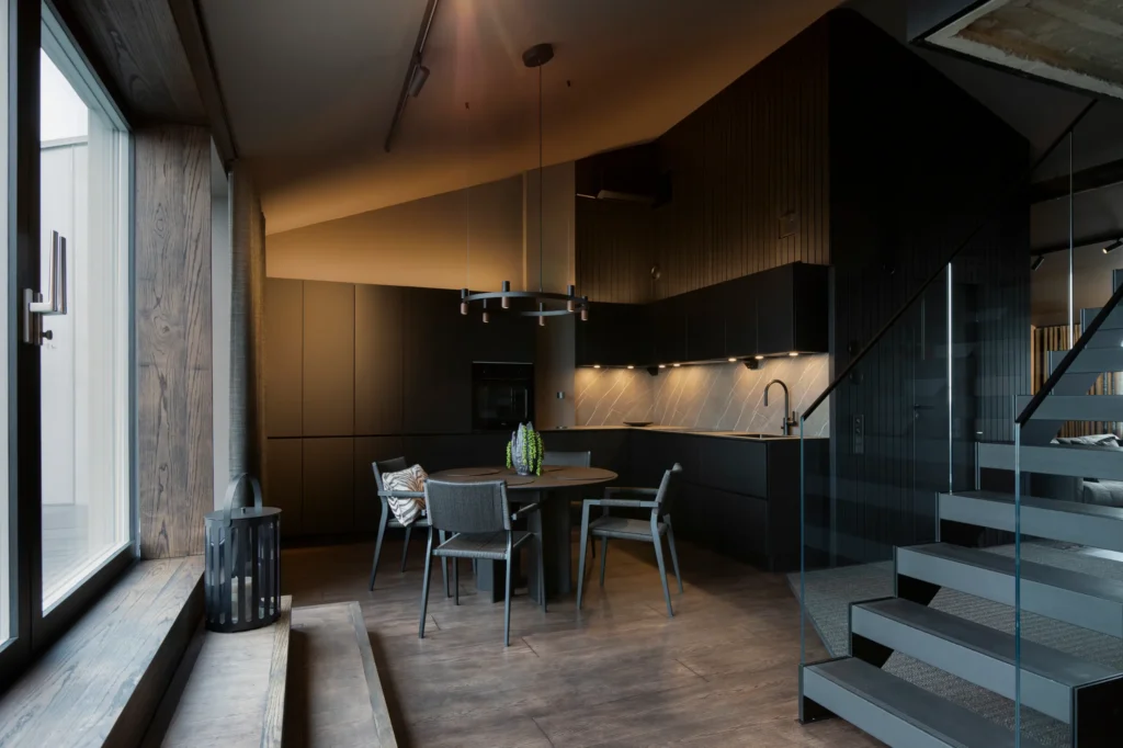 Tyylikäs keittiö ja ruokapöytä, tummat pinnat ja tunnelmallinen valaistus – sisustussuunnittelu Helsingissä